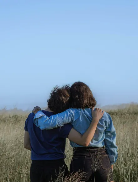 Two people hugging and supporting each other